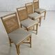 Suite de 4 chaises en rotin cannage et laiton