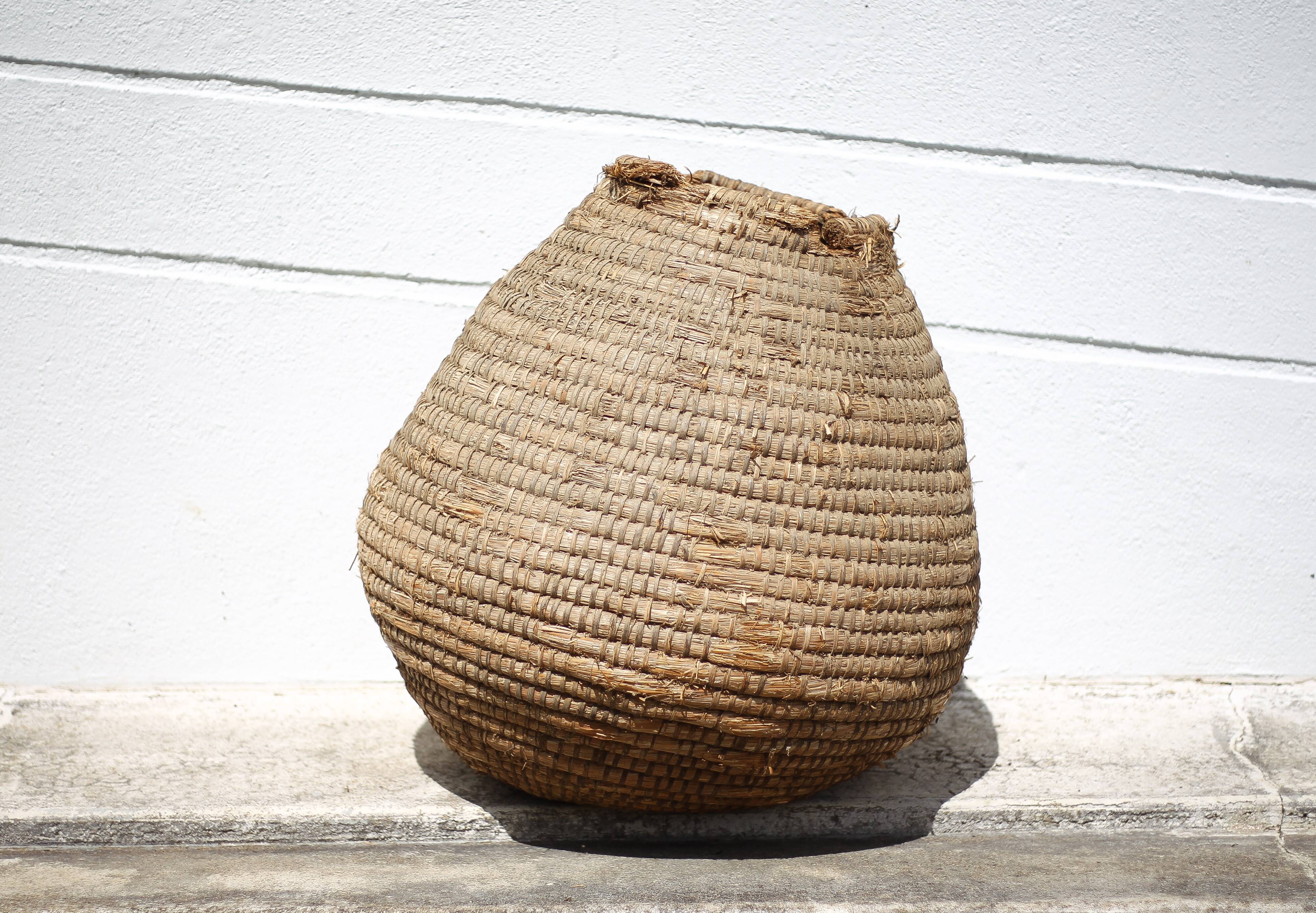 Old basket, burgundy straw and bramble, woven basket, interior decoration, pantry, flowerpot