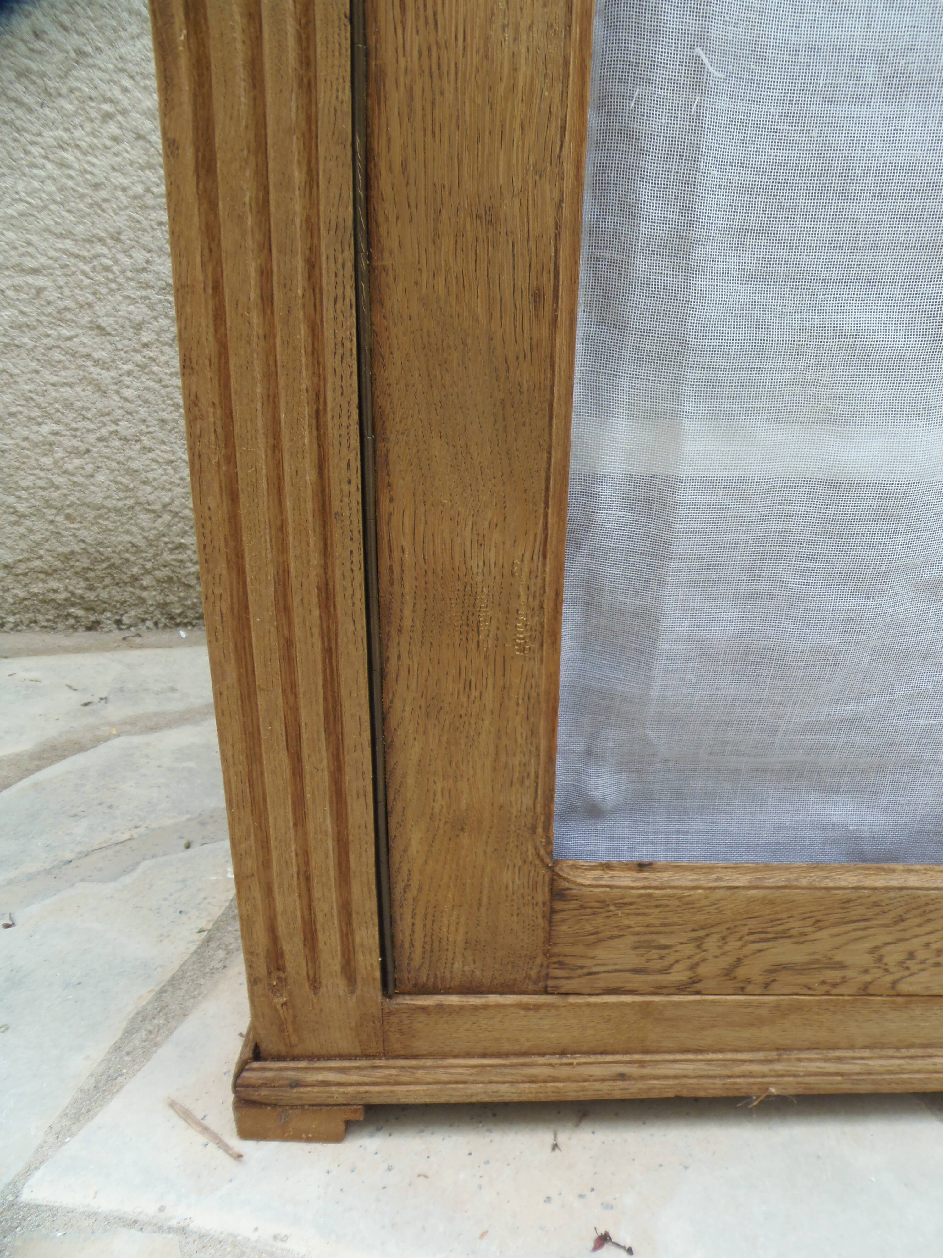 Antique wooden sideboard, fabric doors and pearl grey shelves.