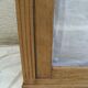 Antique wooden sideboard, fabric doors and pearl grey shelves.