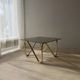 Coffee table with smoked glass and curved metal base