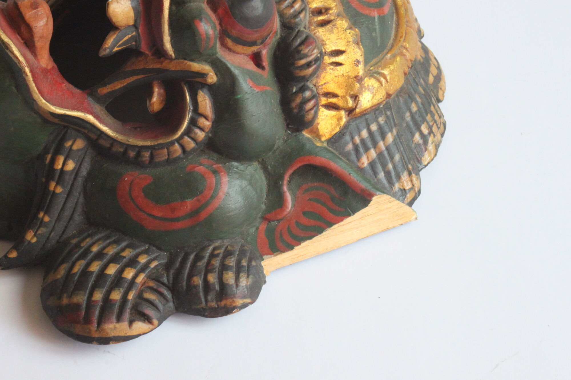 Two polychrome painted and gold leaf gilded Barong dance masks from Bali, Indonesia.