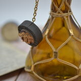 Amber decanter with wicker and golden chain