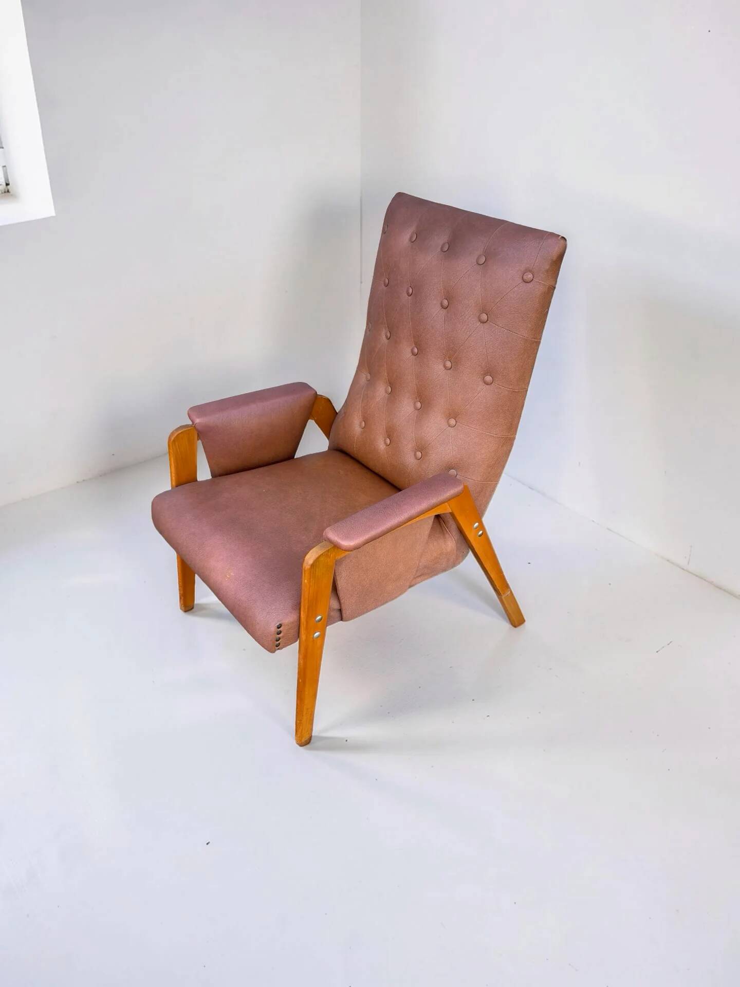 Vintage armchair in light brown faux leather, 1960s.