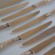 12 silver metal table knives 25.5 cm