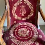 Paire de fauteuils Empire bordeaux à motif lyre , pieds sabre, accotoirs sculptés têtes de dauphin X