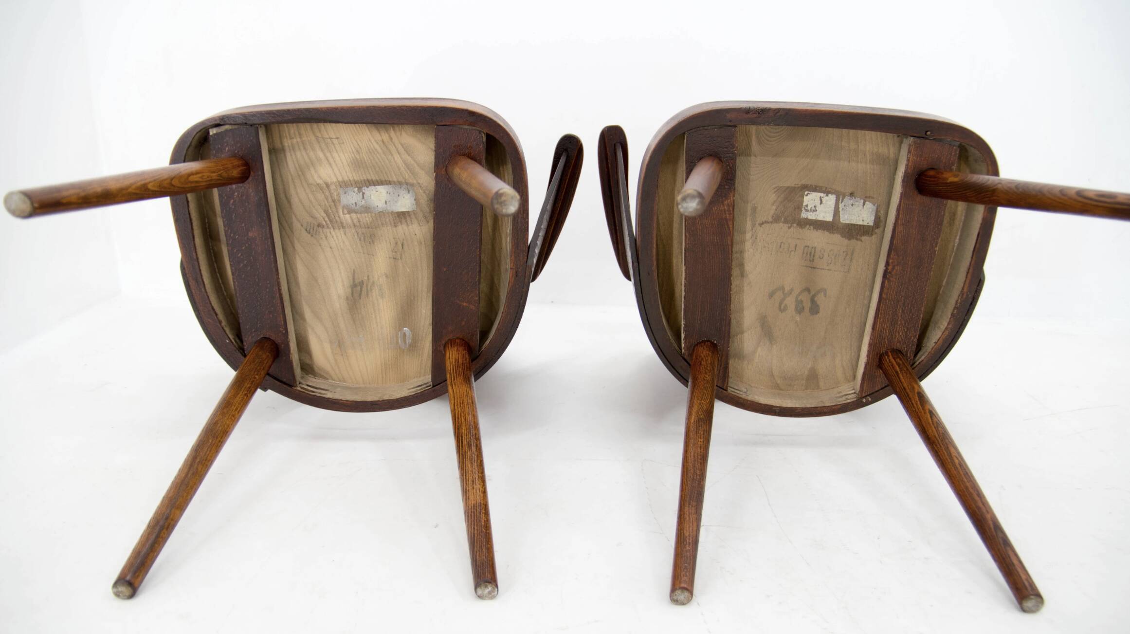 Pair of curved wooden shell armchairs in the style of Oswald Haerdtl.