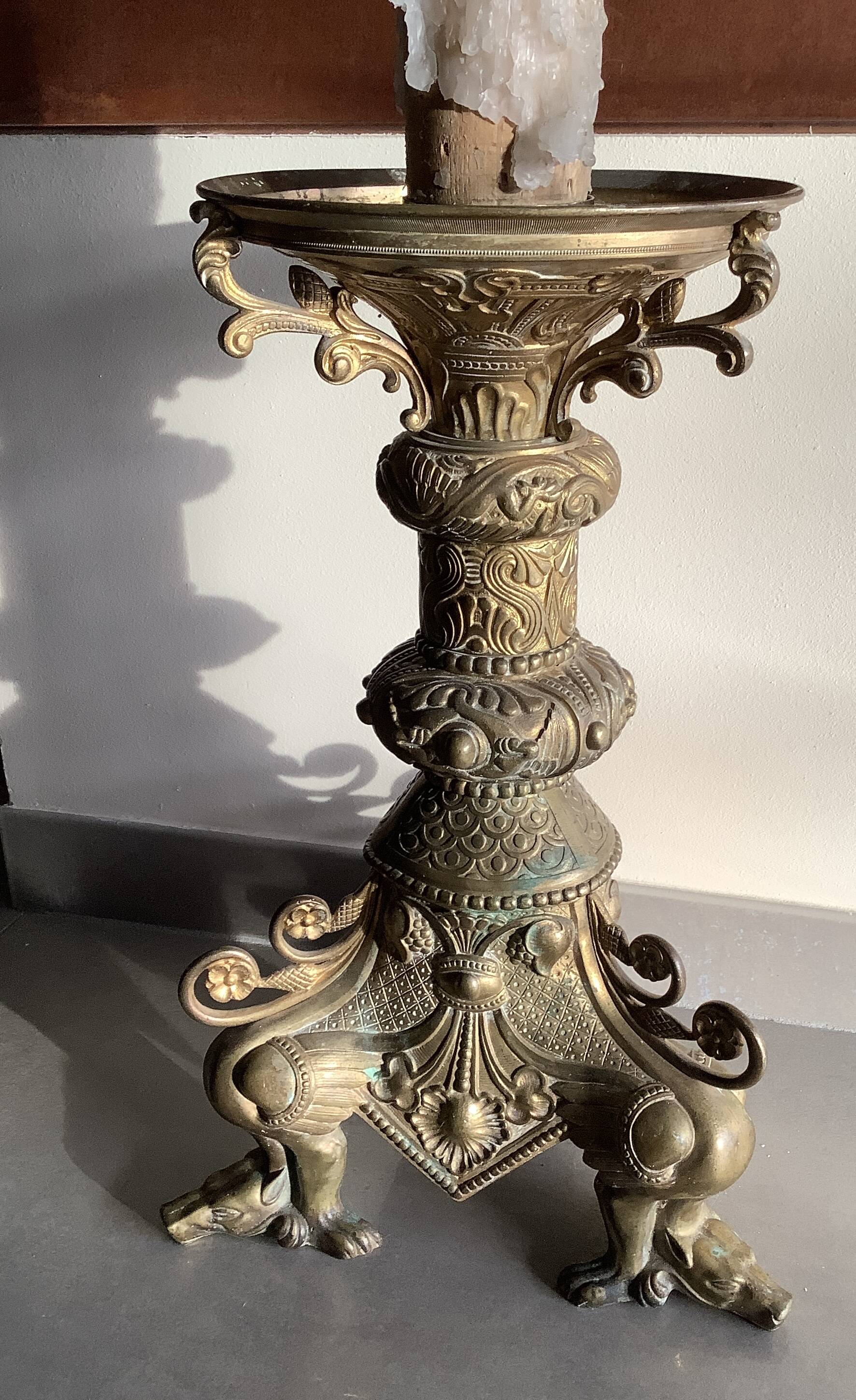 Large bronze candlestick with tripod and winged dog decoration, 19th century.