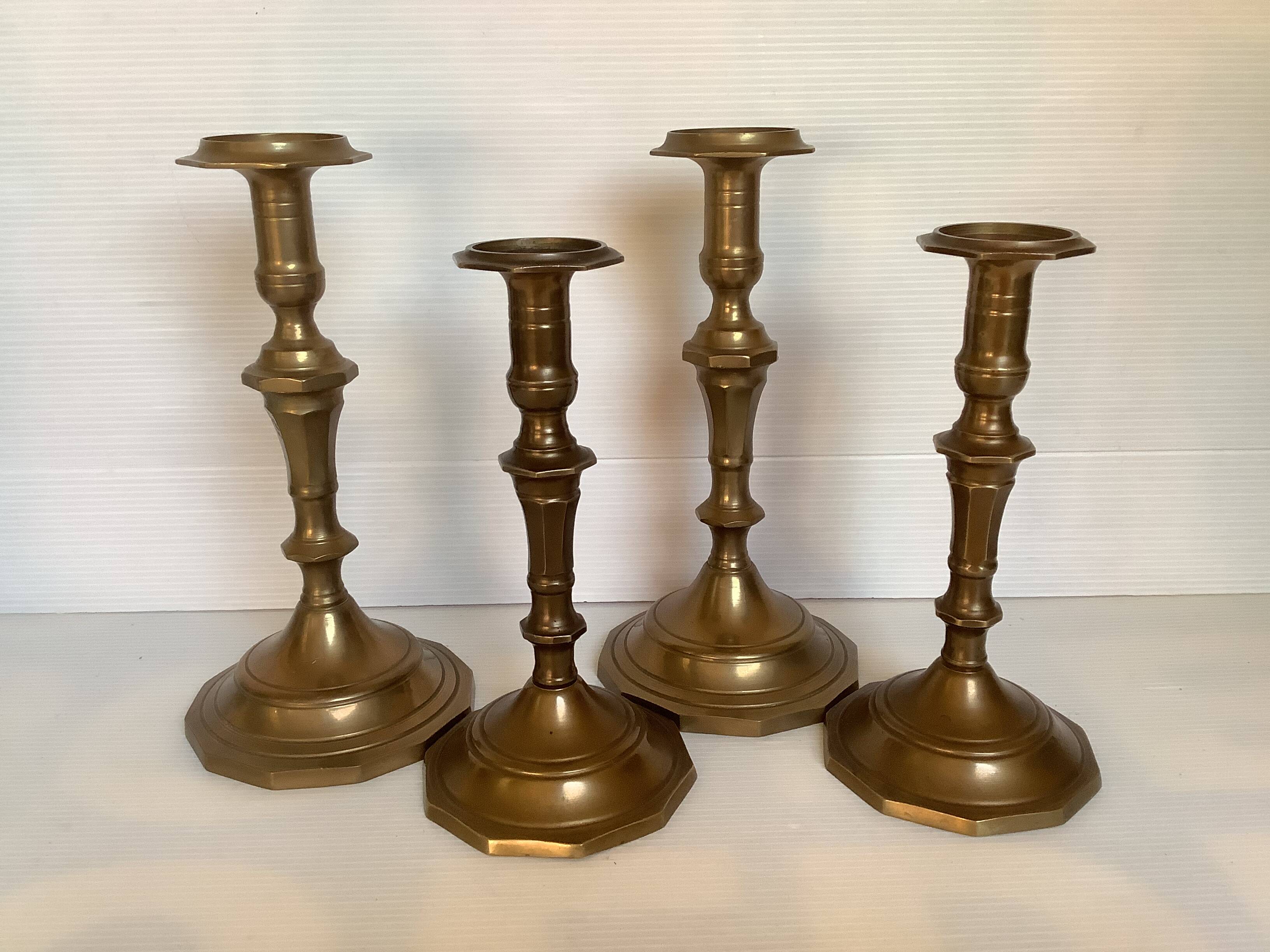 Four brass candle holders