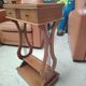 Vintage end table with lyre legs and two drawers.