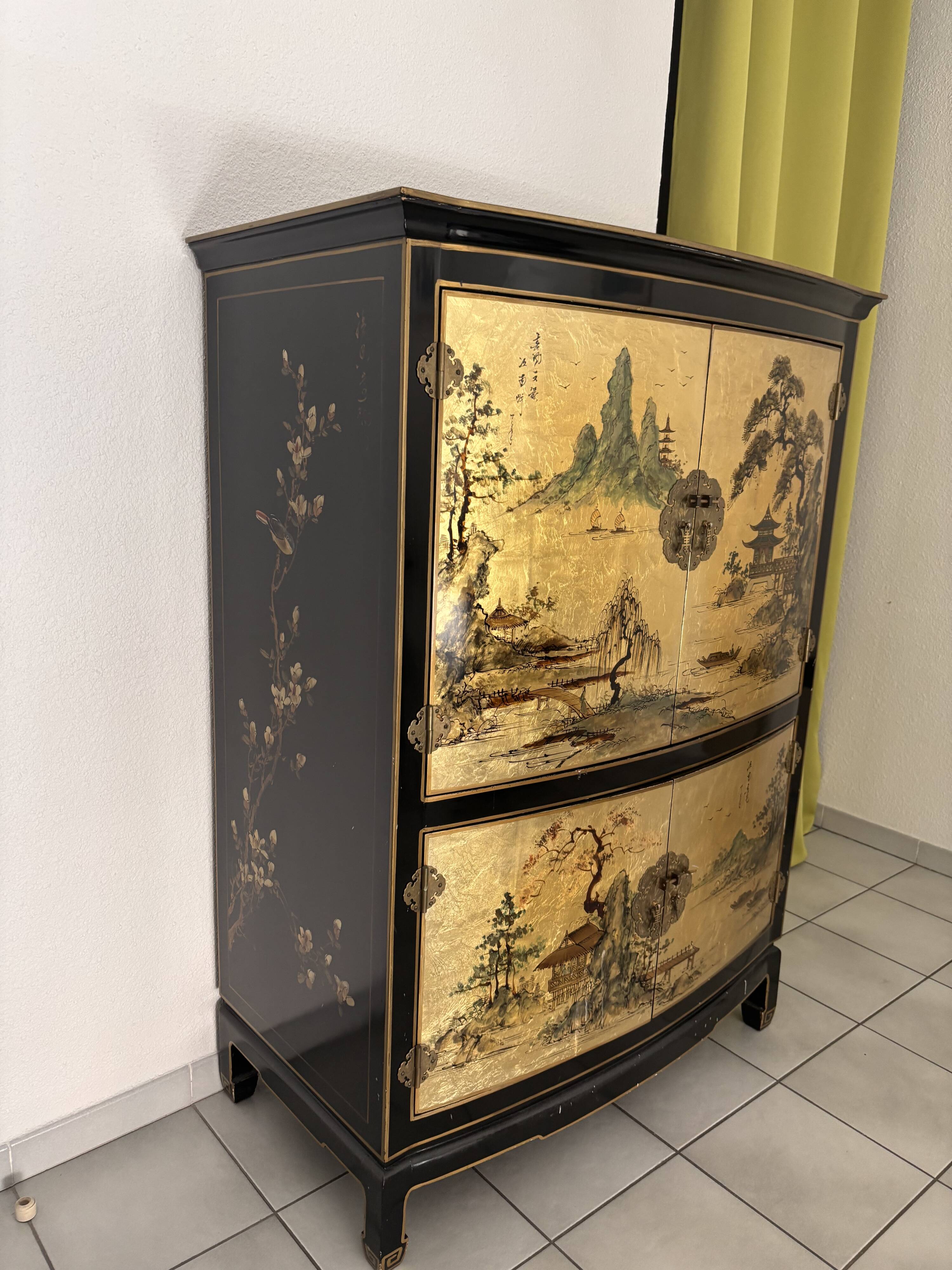 Curved bar cabinet inspired by Chinese design, black lacquer and red interior.