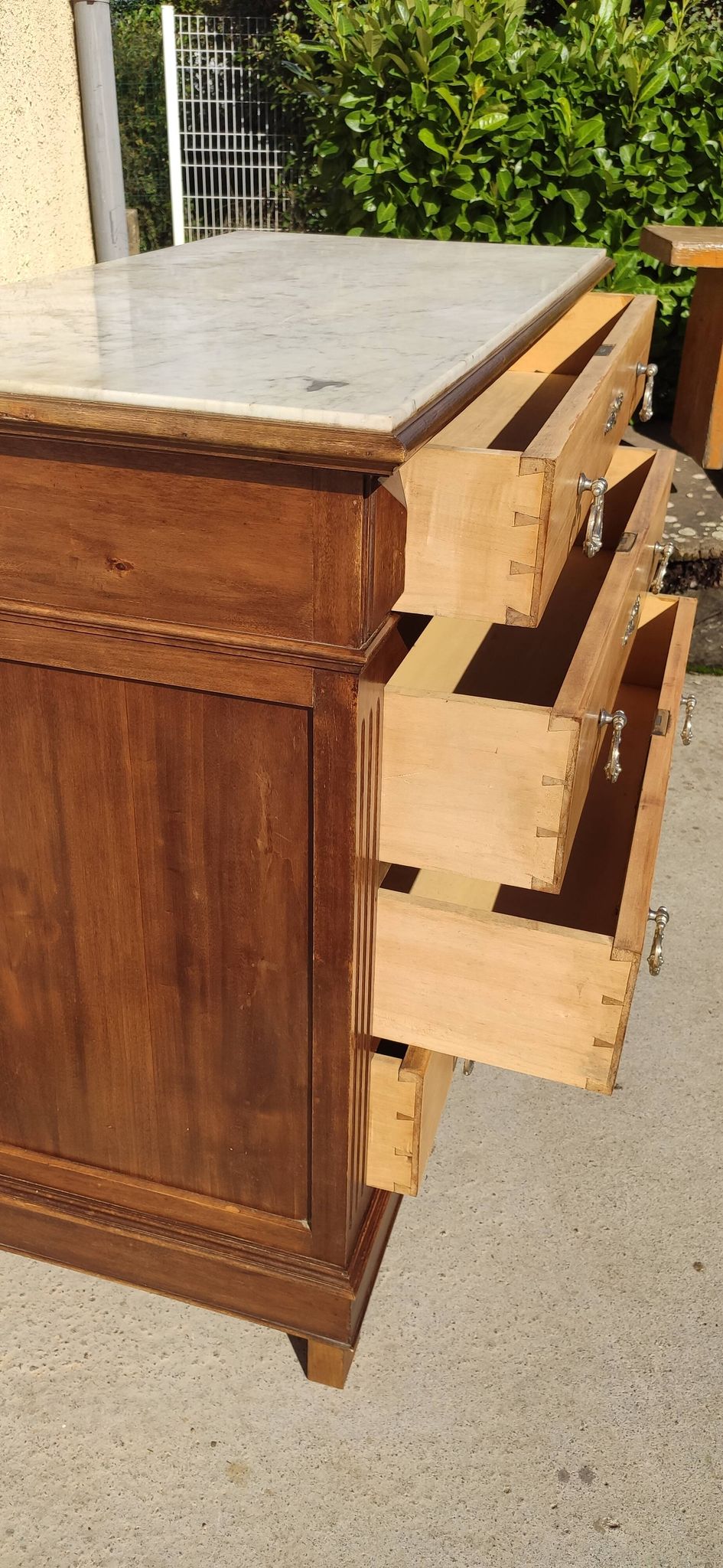 Old chest of drawers with white marble.
