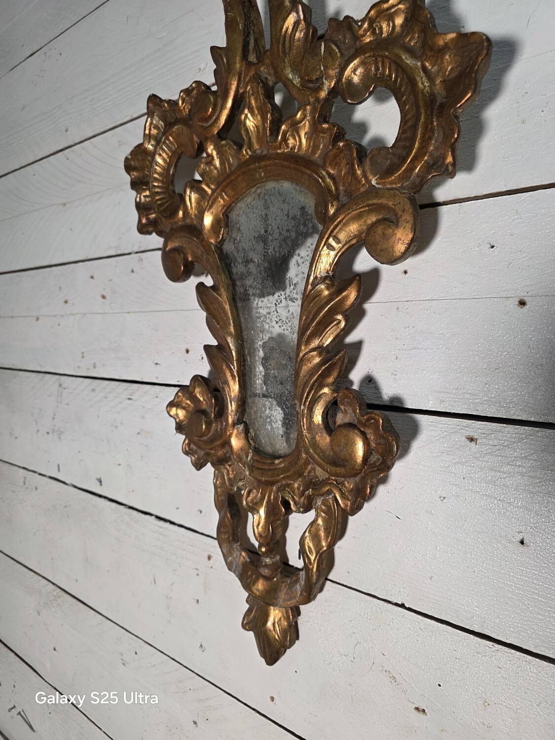 Italian mirror in gilded wood with gold leaf from the 18th century.