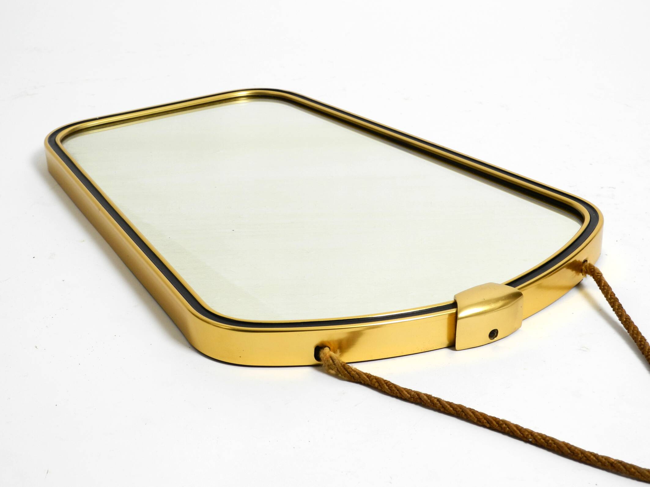 Beautiful small mid-century brass wall mirror with braided hanging strap