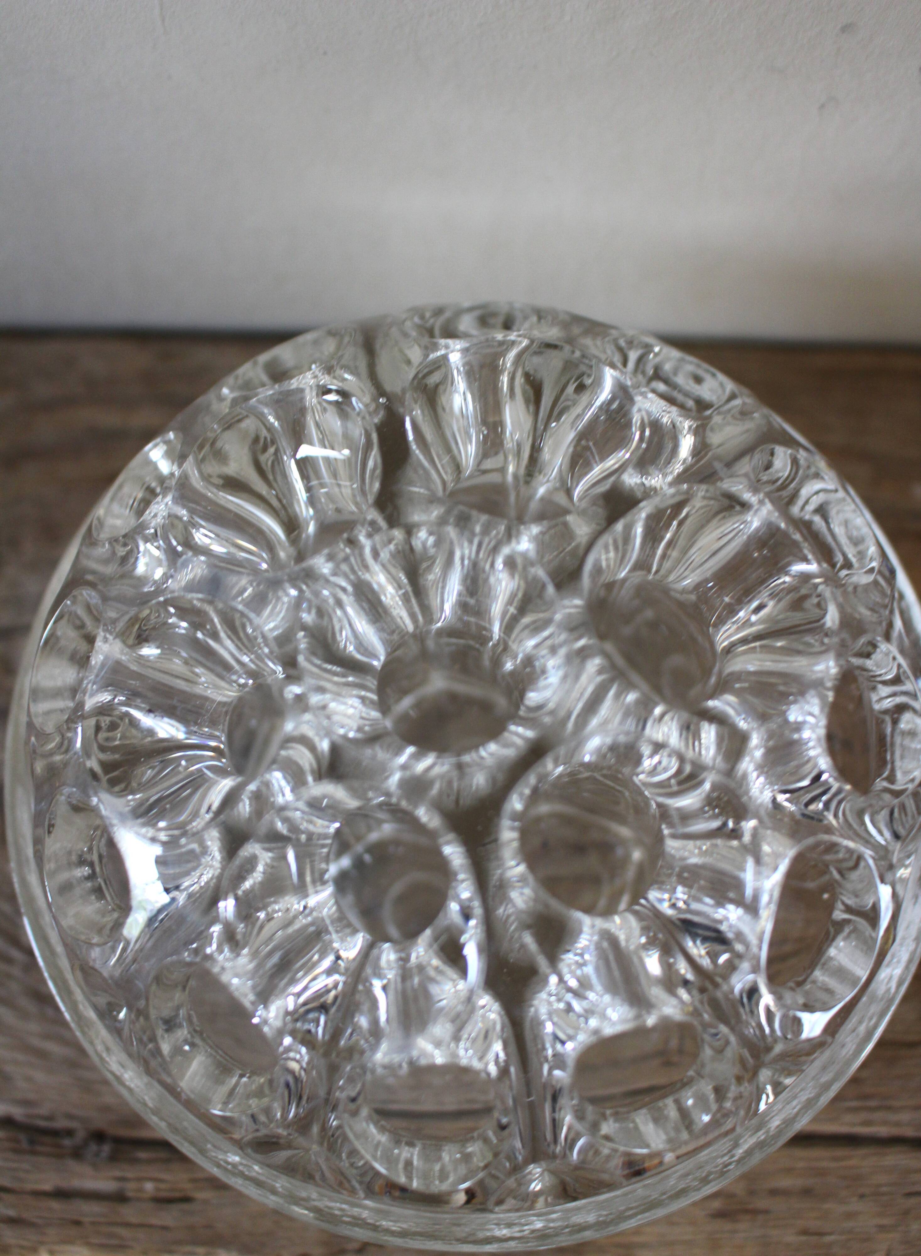 Large round glass flower frog vase with 19 holes.