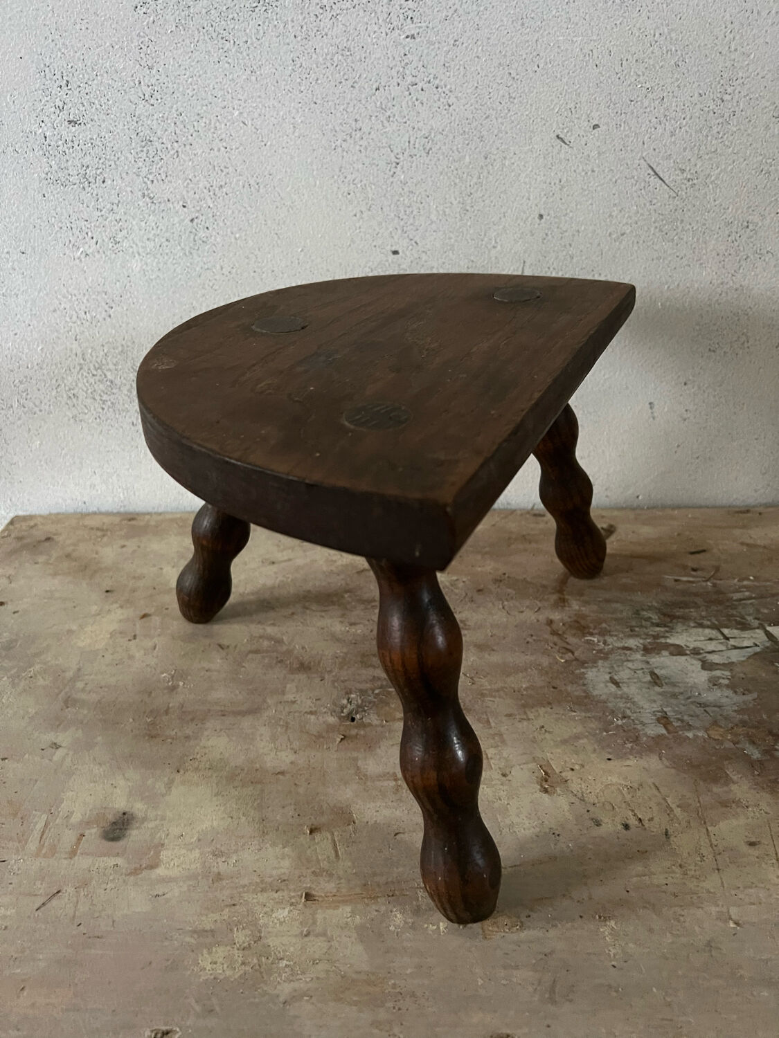 Wooden tripod farm stool