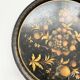 Round plateau, 19th century, painted black with fruit and grape decoration (49 cm)