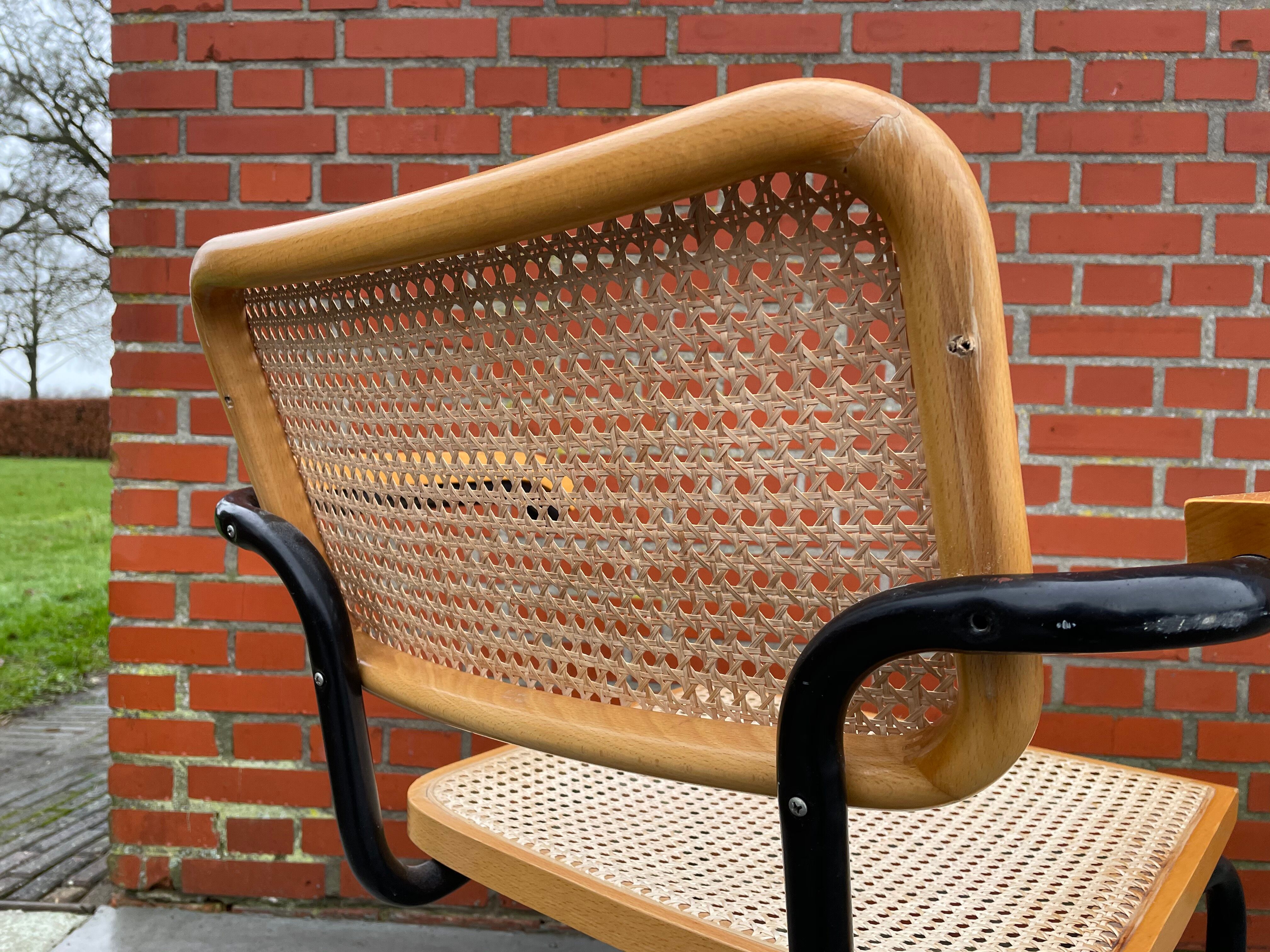 Cesca model chair designed by Marcel Breuer with black-framed armrests