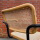 Cesca model chair designed by Marcel Breuer with black-framed armrests