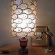 Table lamp with wooden base and mother-of-pearl fish and brass lampshade