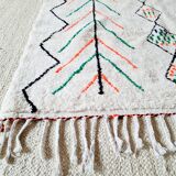 White wool Berber rug with fluorescent orange green patterns
