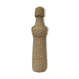 Bottle surrounded by wicker or raffia