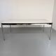 Large table design USM Haller with a white top and chrome structure.
