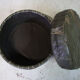 Pouf in black/green leather