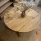 Large round antique coffee table made of raw solid wood.