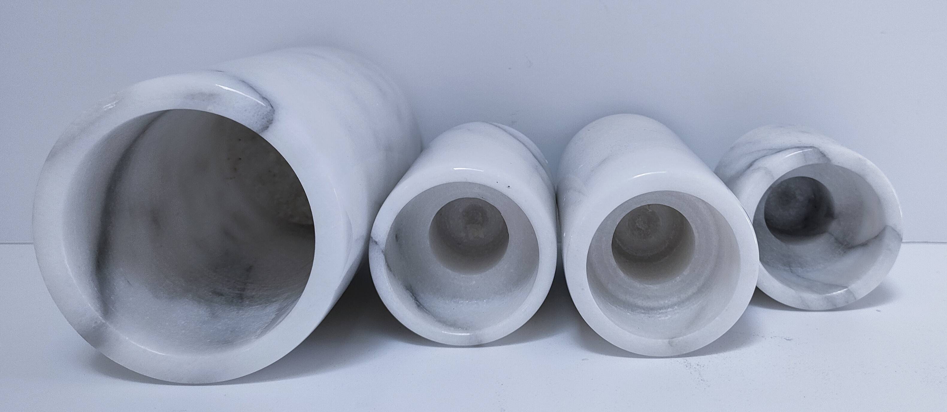 Four white marble candlesticks with black veins, 70s design