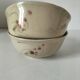 Two large vintage bowls in pastel decor on mini pedestals.