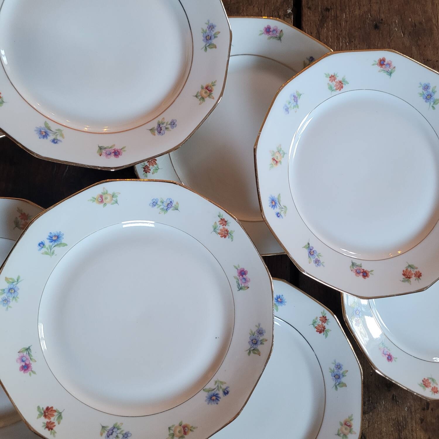 8 porcelain dessert plates with gold rim and various flowers