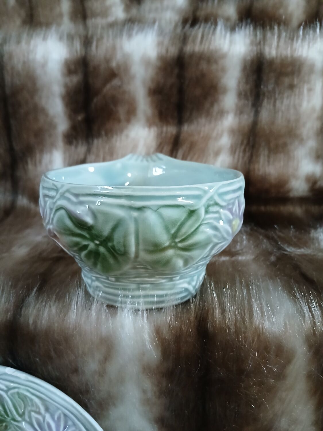 Antique cup and saucer in majolica.
