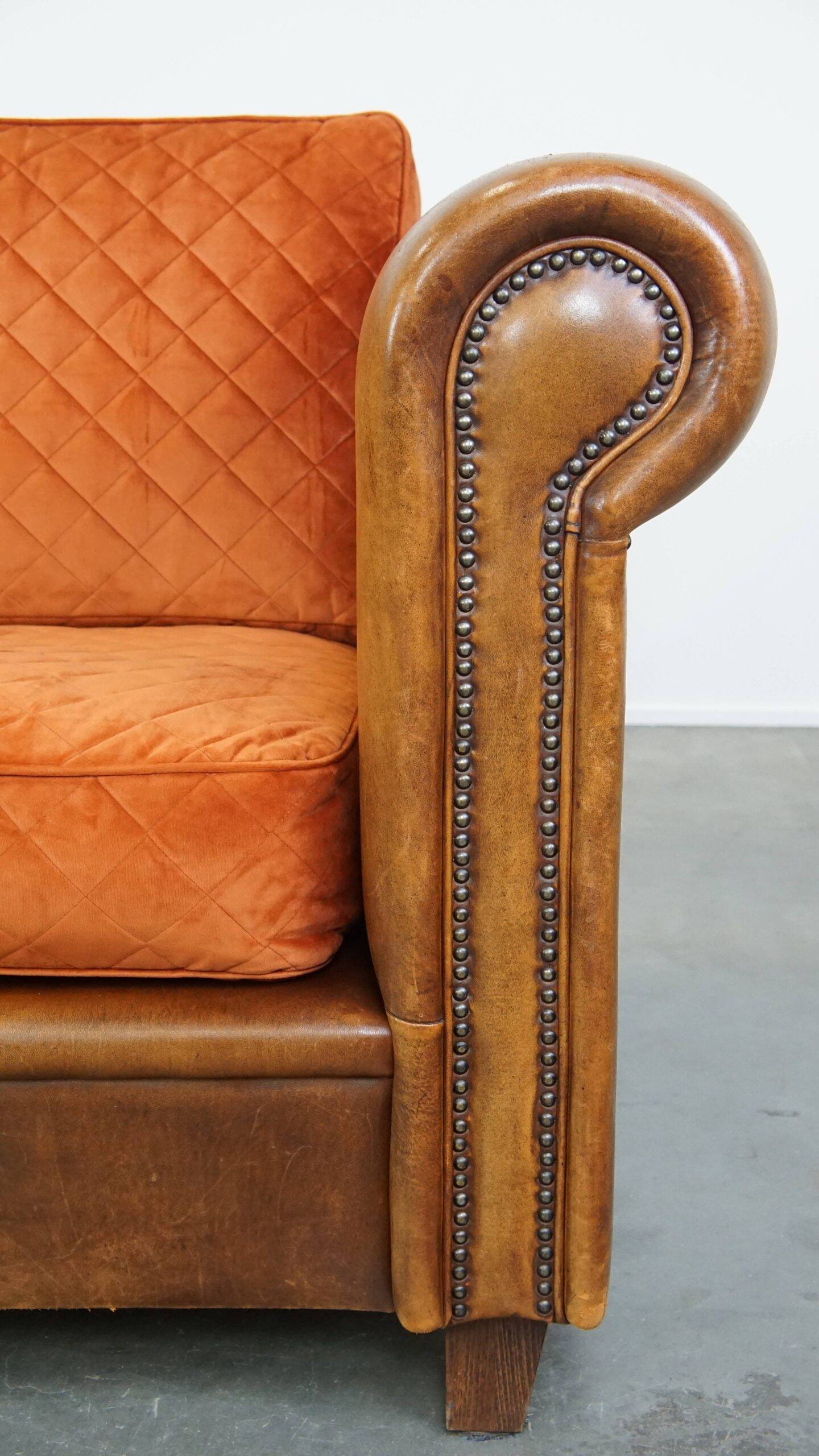 Luxury and comfortable sheepskin 2.5-seater sofa of top quality with orange fabric seat and back cushions