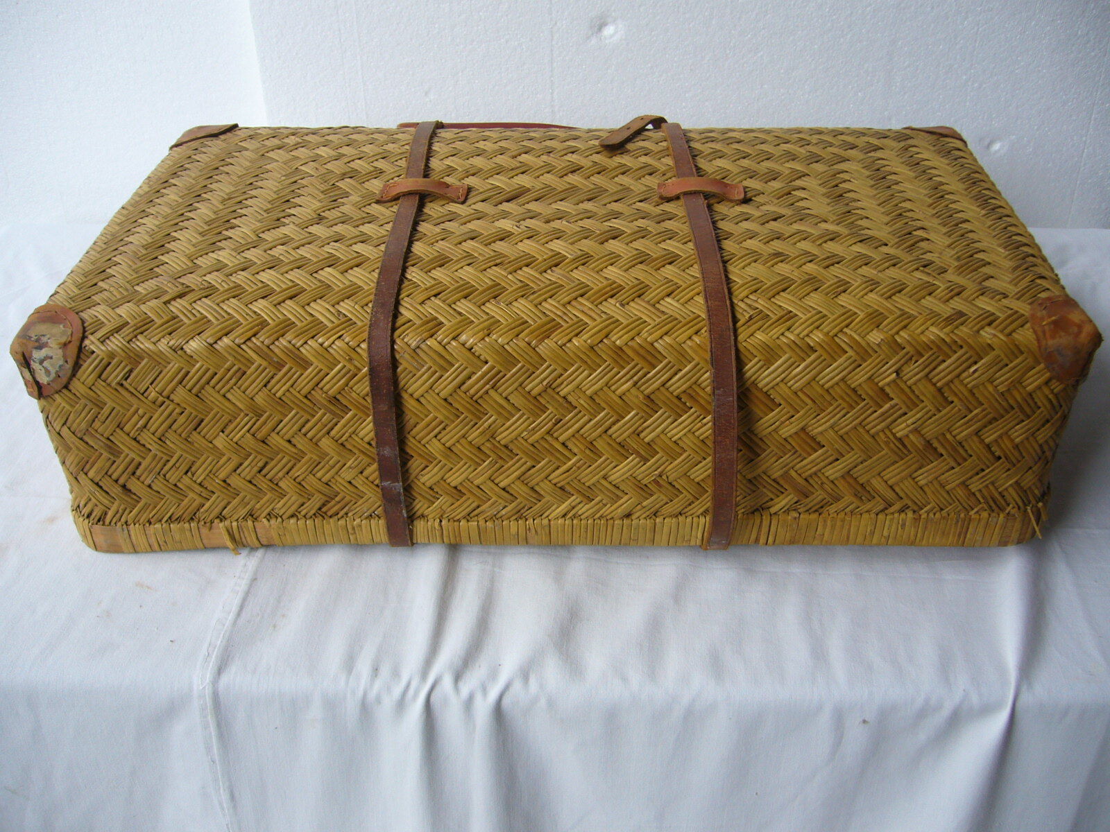 Old rattan case with leather straps and wooden handle