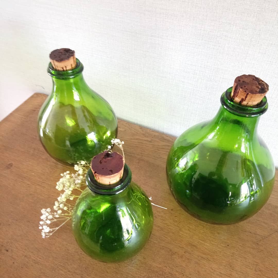 3 green glass bottles