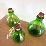 3 green glass bottles