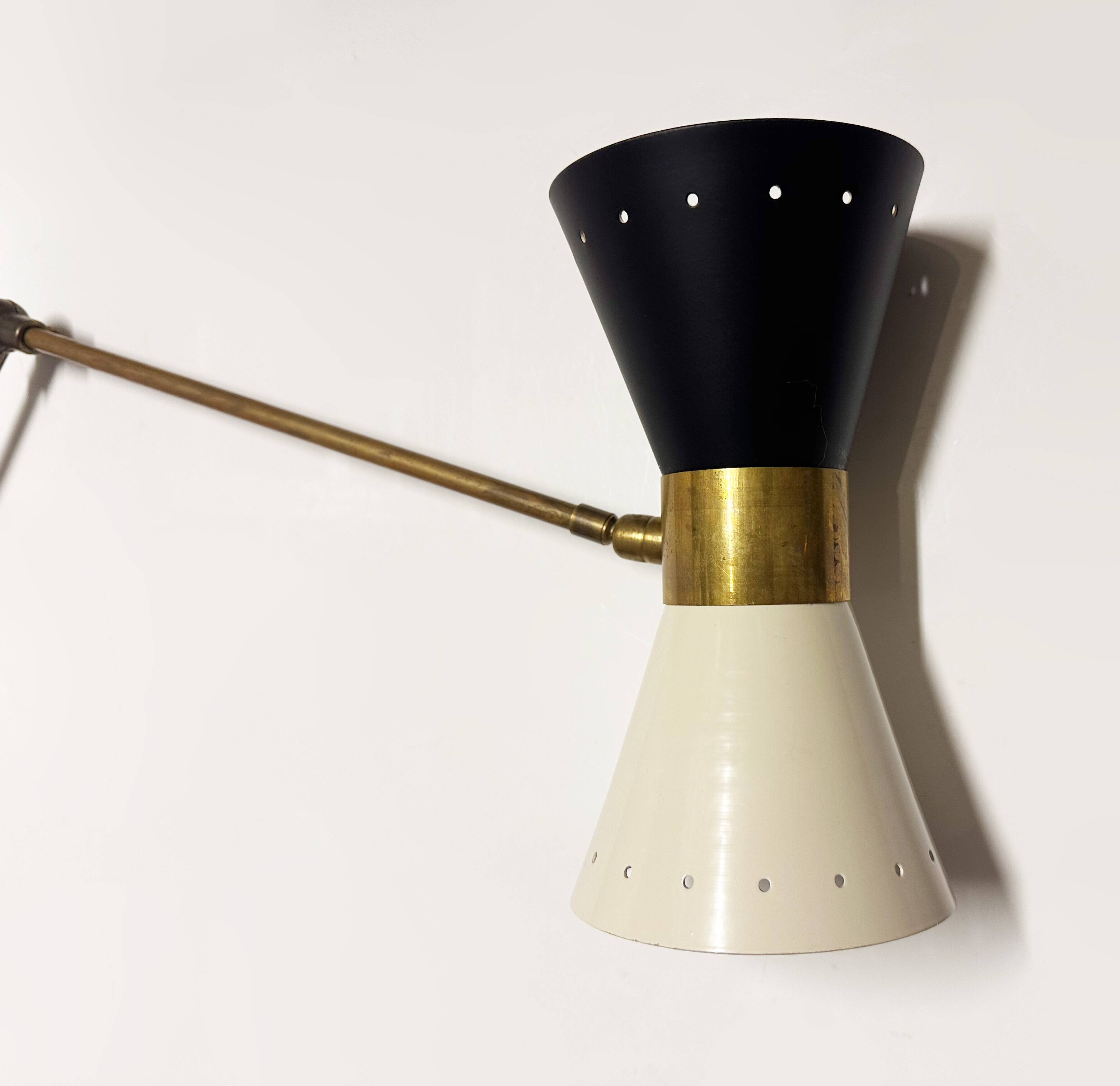 Articulated brass and lacquered iron wall light, 1950s design.