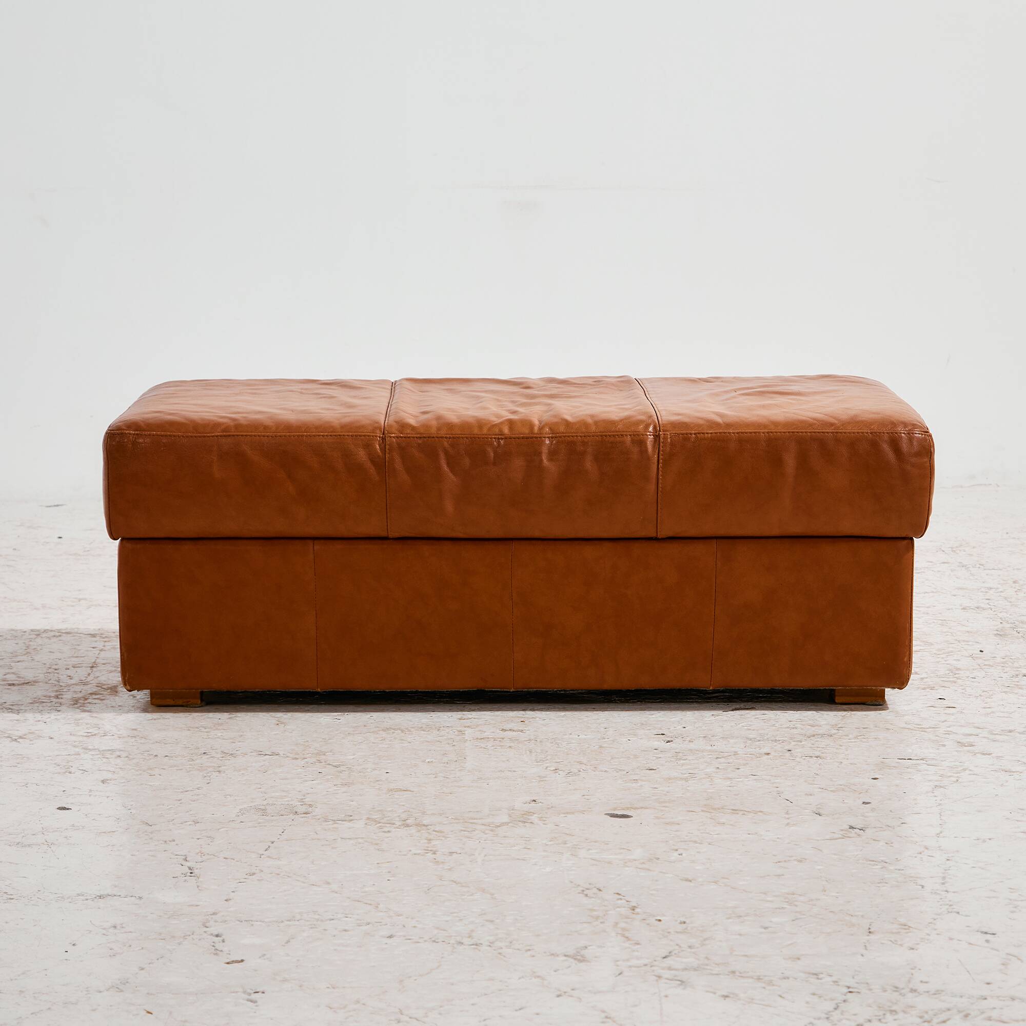Ottoman with leather upholstery