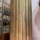 Large fluted golden wood column with a marble top, work from around 1900.