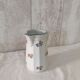 Earthenware milk jug with small flower patterns.