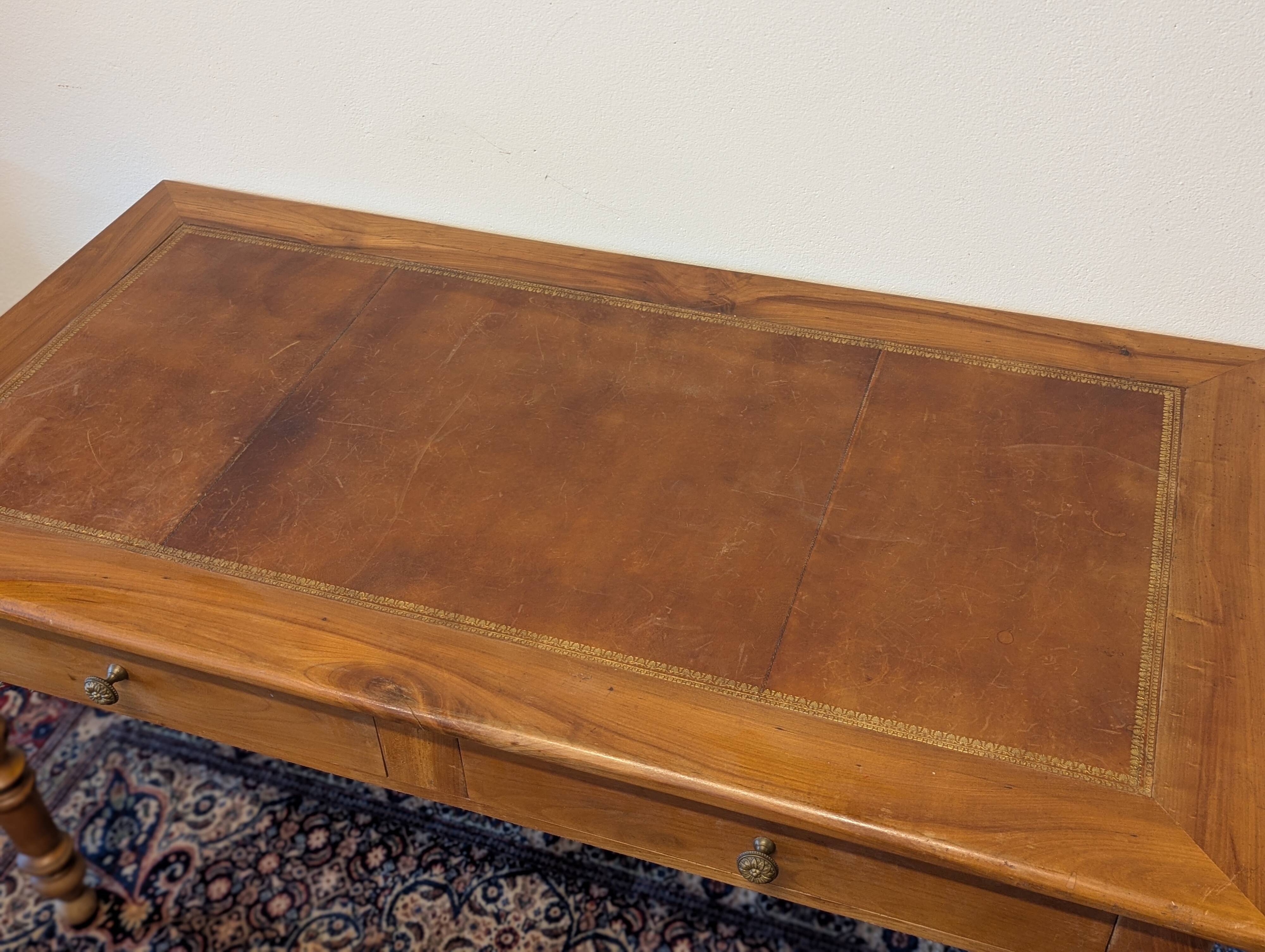 Cherry wood desk with a leather top.