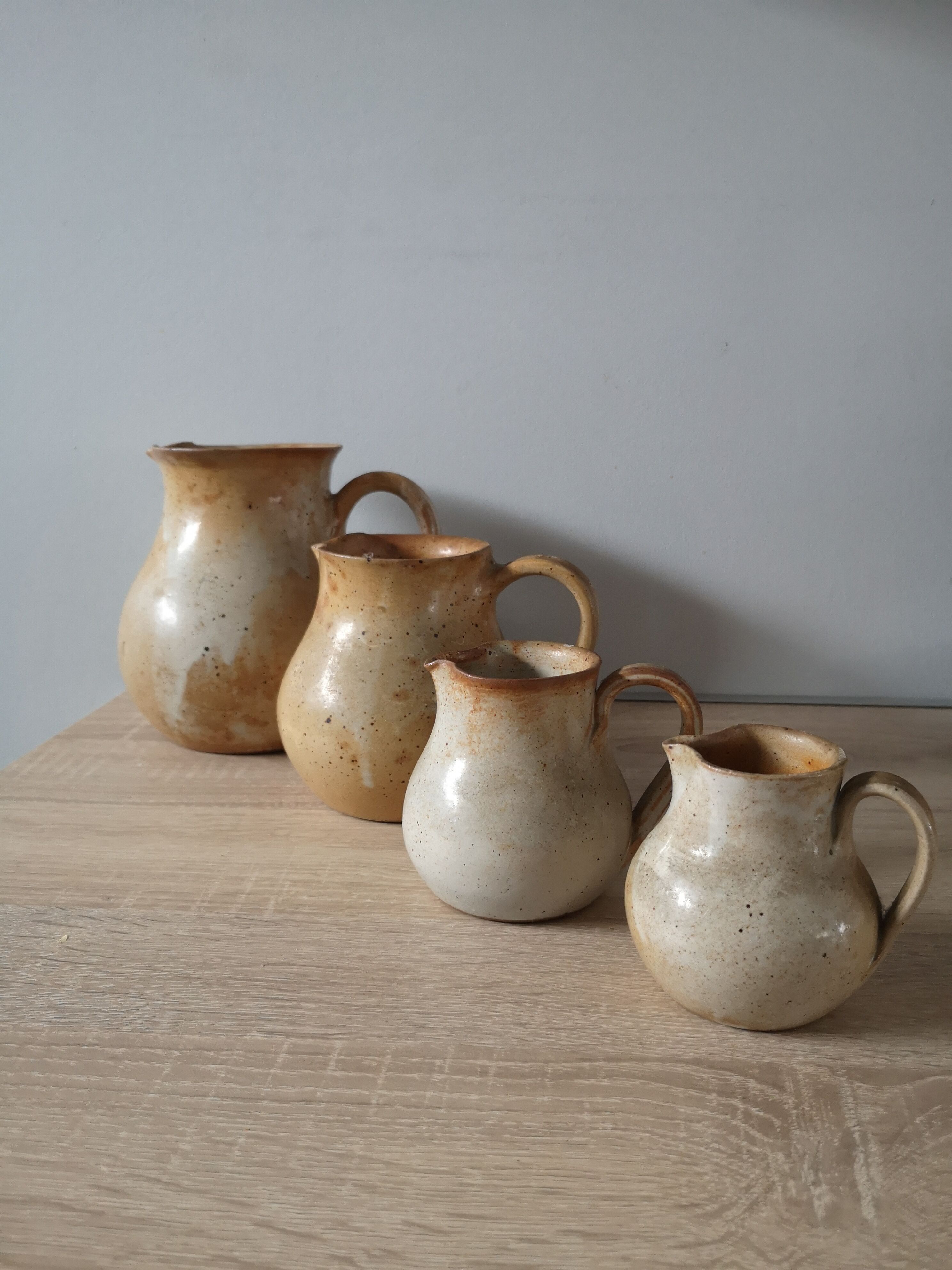 Lot of 4 pitchers in sandstone