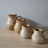 Lot of 4 pitchers in sandstone