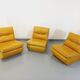 Suite de 3 chauffeuses Roche Bobois vintage en cuir jaune moutarde années 70