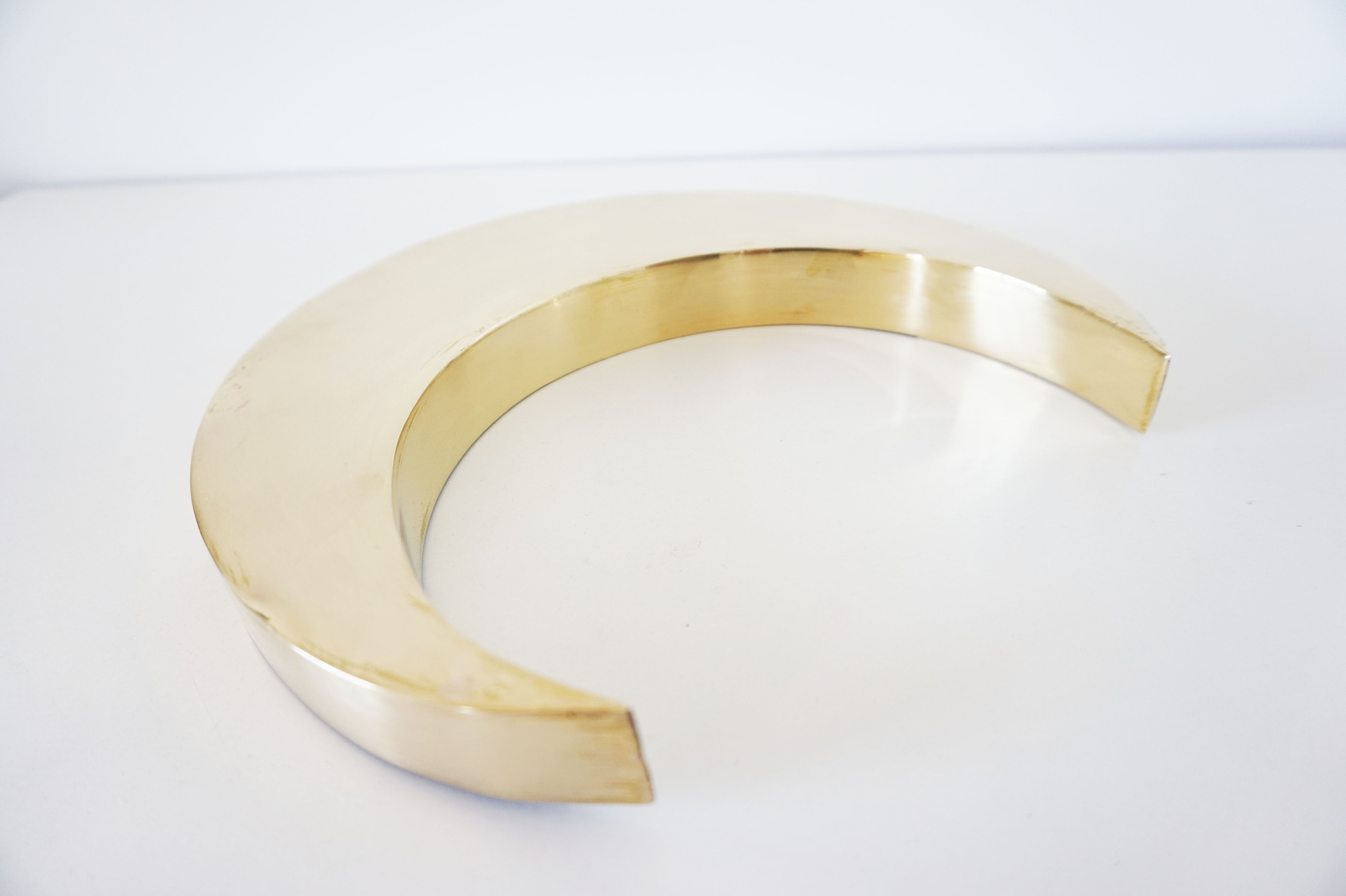 Moon or letter of sign "C" in vintage brass