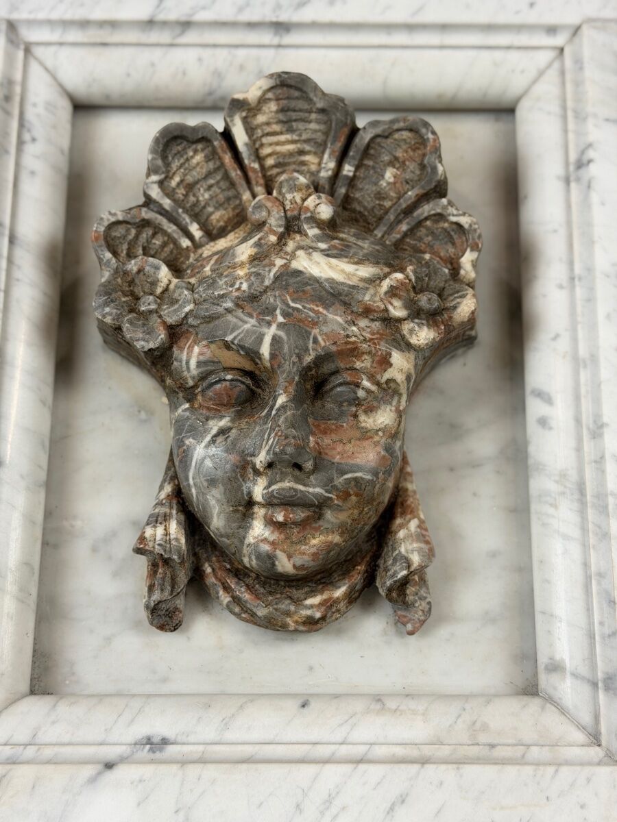 Female mascaron in grey Ardennes marble from the Regency period, 18th century.
