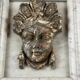 Female mascaron in grey Ardennes marble from the Regency period, 18th century.