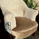 Pair of beige bouclette fabric frog chairs and their footrest.