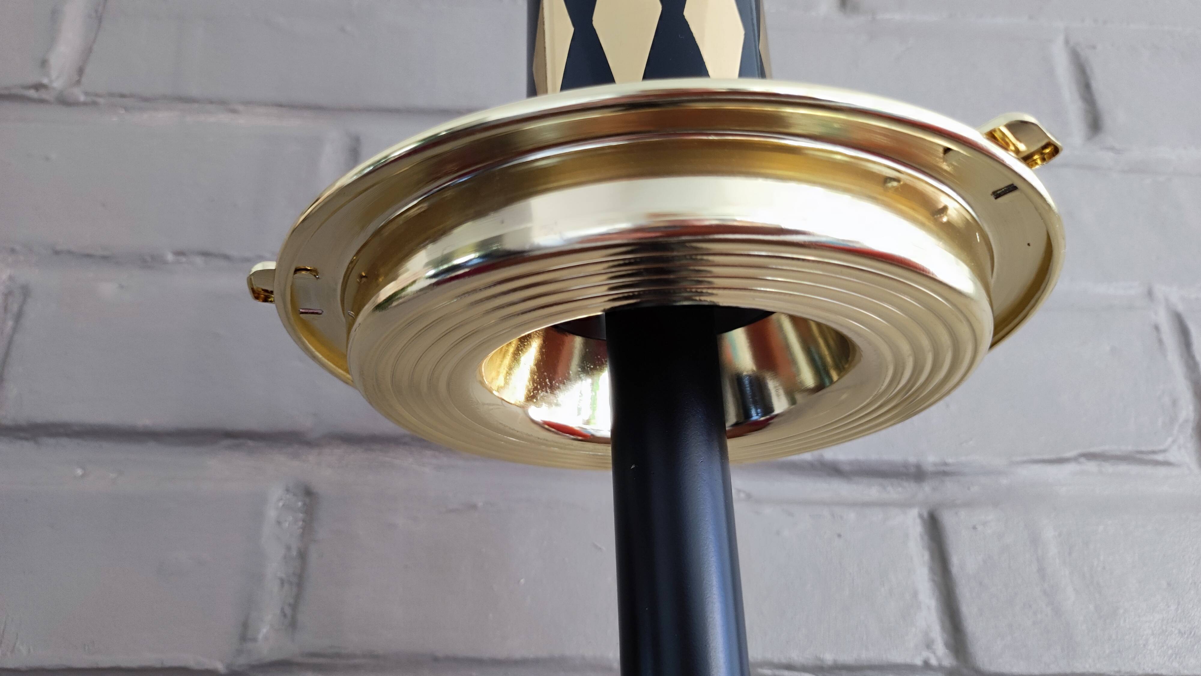 Vintage floor ashtray with a gold and black metal cigarette dispenser.